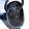 Apachenträne oder Rauchobsidian ist ein sehr dunkler transparenter Obsidian. Er ist ein kraftvoller Stein aus vulkanischem Glas (geschmolzenes Quarz). Schwärzlich, dunkelbraun, im Licht durchscheinend. Laut einer indianischen Sage, die von vielen Indianerstämmen der USA erzählt wird, hat die Apachentränen folgenden Ursprung: "Als der weiße Mann in die Welt des roten Mannes kam, verloren die Indianer immer mehr Land. Sie zogen sich immer weiter nach Westen zurück und wurden letzendlich im Gebiet des heutigen Arizonas zusammengedrängt und gezwungen, nun auch ihr letztes Land abzugeben. Dies machte die Indianer so unendlich traurig, daß das ganze rote Volk anfing zu weinen. Ihre Tränen fielen auf ihre geliebten Weidegründe und erstarrten zu wunderschönen dunklen Steinen, zur Erinnerung an die Apachen." Seither sind die Apachentränen bei allen indianischen Stämmen bis heute das Symbol von Freiheit, Kraft und Gesundheit. Der Rauchobsidian ist ideal für die Meditation. Er kann Blockaden abbauen und entspannen.